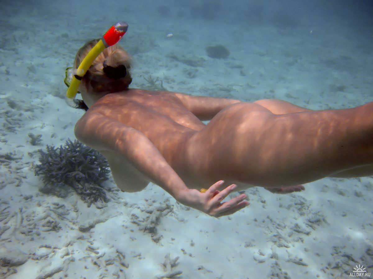 Naked male diving.